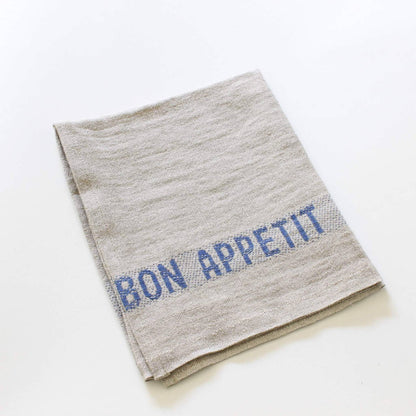 Serviette Bon Appetit aus Leinen natur mit blau gewebten Schriftzug 